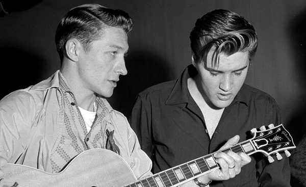 LOS ANGELES - JUNE 4:  Elvis Presley and Scotty Moore rehearse for their appearance on the Milton Berle Show at the NBC Burbank studios on June 4 1956 in Los Angeles California. (Photo by Michael Ochs Archives/Getty Images)
