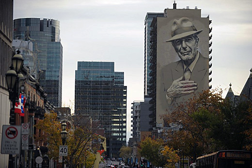 A mural of musician Leonard Cohen is seen on a building on November 7, 2017 in downtown Montreal. Leonard Cohen's songs strived for the universal and his voice was often solemn, yet the courtly songwriter had plentiful moments of joy and deadpan humor. One year after Cohen died at age 82, an array of artists testified to his far-reaching impact with a concert the evening on November 6, 2017 whose somber yet graceful tone befitted the celebrated singer and poet. Before more than 21,000 people at the Bell Centre arena in Cohen's native Montreal, the tribute built around short videos of his well-traveled life which included years of artistic retreat on the Greek island of Hydra and a late-age stint as a Buddhist monk in California. / AFP PHOTO / Marc BRAIBANT